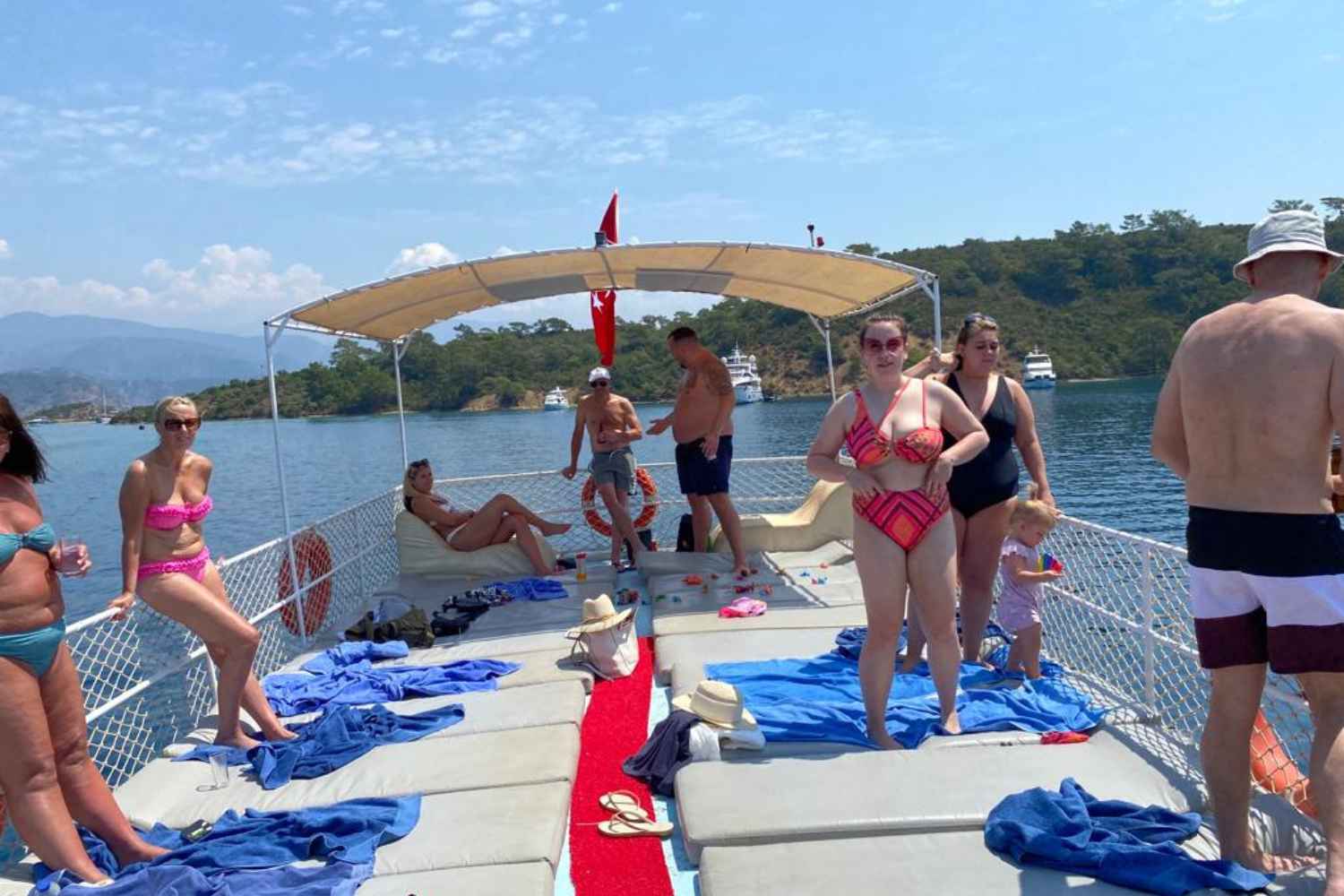 Boat Trip, Sunbathing Customers on the upper deck of the Boat. Trip is known as 12 Island Boat Trip. Pick Up and Lunch included. Swim in bays and coves of Gocek. Pick Up from Sarigerme and Dalaman Hotels
